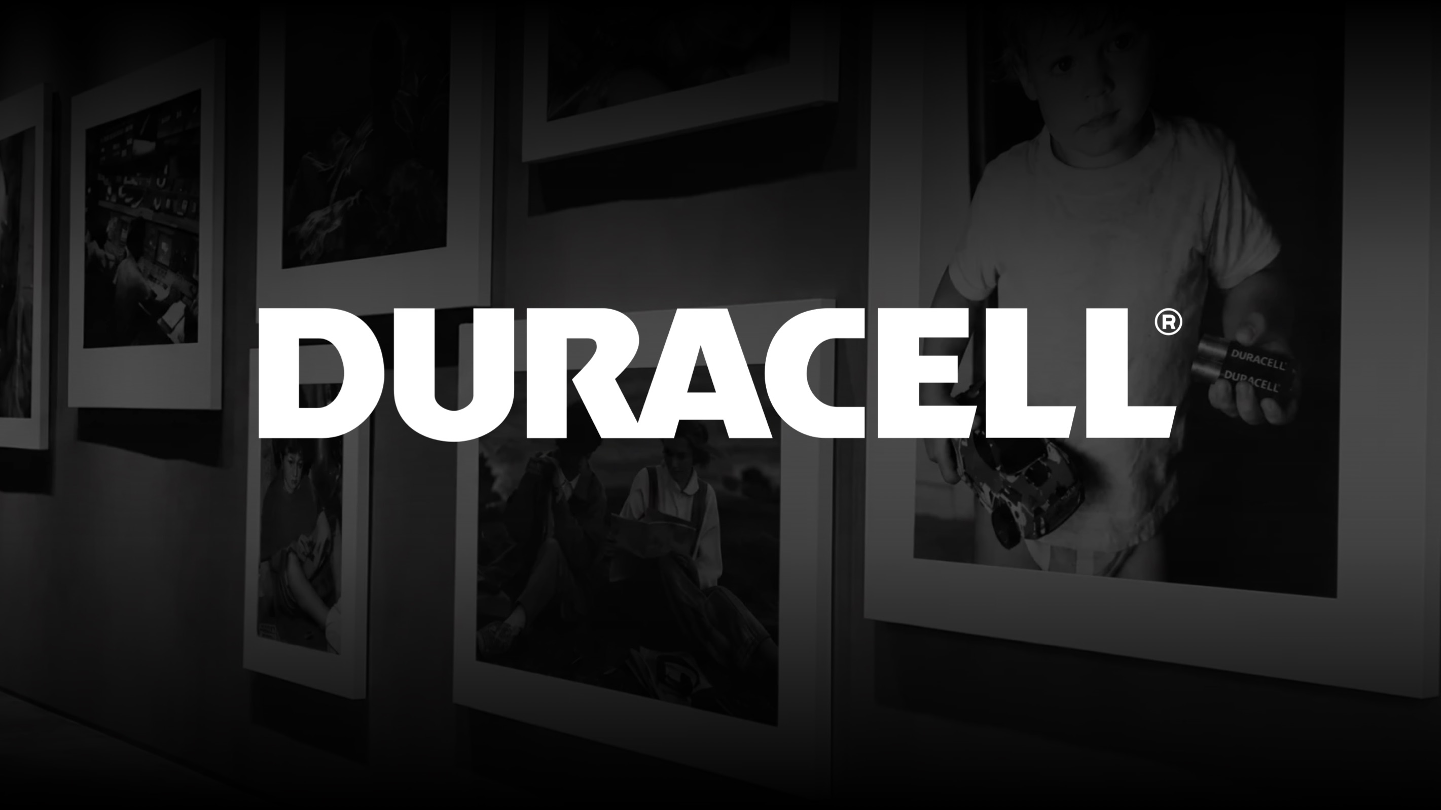 Duracell logo over a gallery wall of the ad's photographs